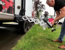 Deploy steps by pulling on the bottom step. Requires as little as six inches of clearance on the side of the RV from any nearby object or obstruction to deploy the steps. 